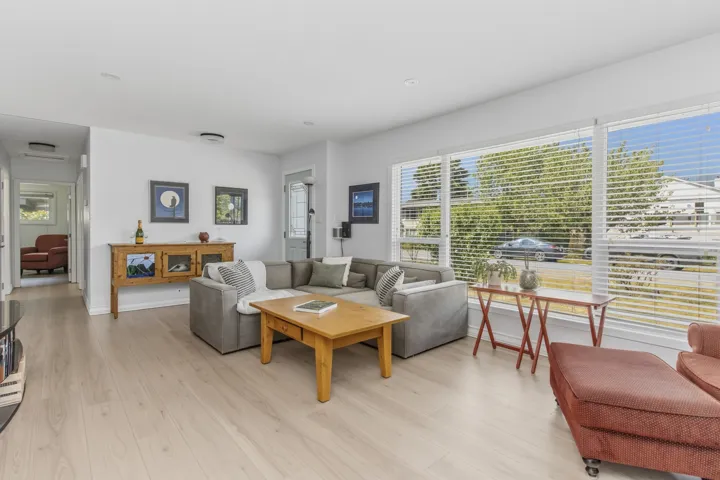 Living space featuring light wood-finish flooring, white walls, and recessed lighting