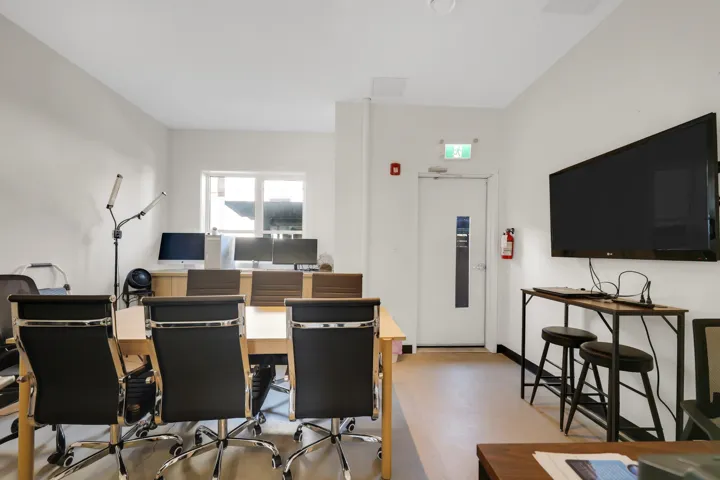 Versatile interior space featuring light-toned walls and wood-finish flooring