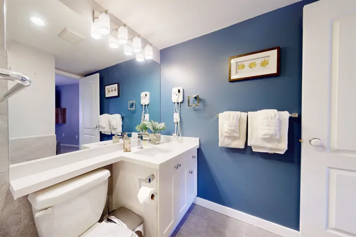 Bathroom with baseboards, visible vents, toilet, tile patterned floors, and vanity