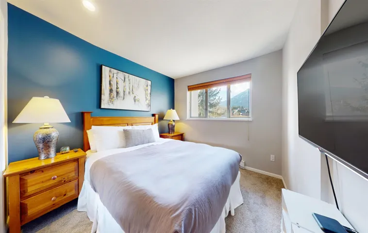 Bedroom featuring carpet flooring and baseboards
