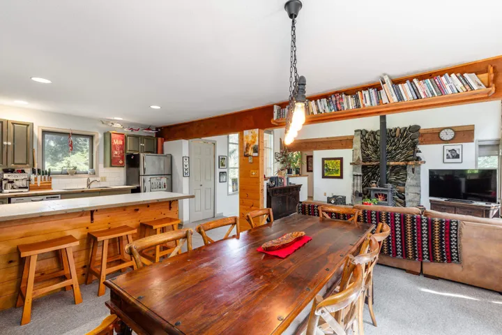 Dining area featuring a substantial wood table and a linear chandelier