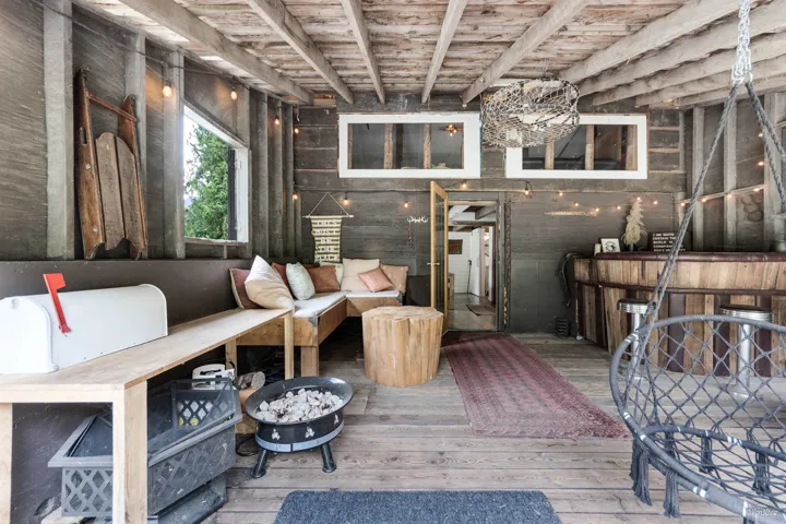 Living area featuring light wood-type flooring and a wood ceiling with exposed beams