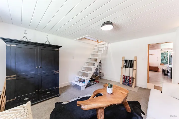 Living area with light colored carpet