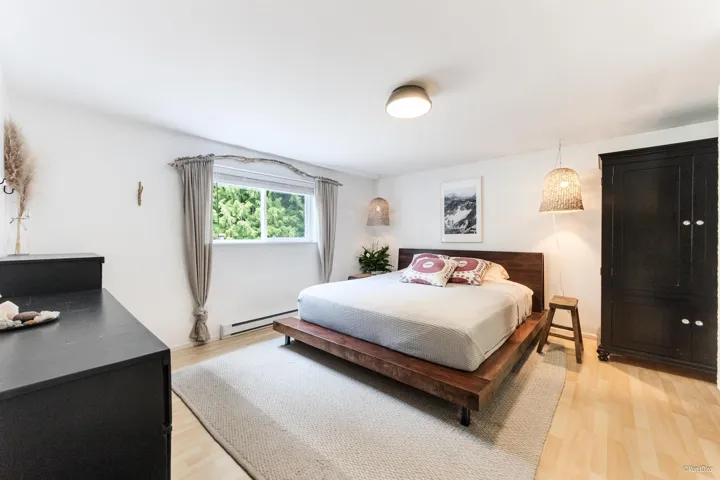 Bedroom with light wood-style flooring and a baseboard radiator