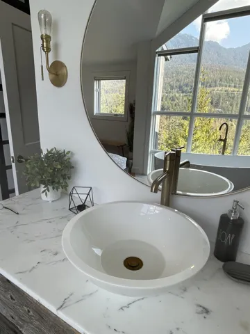 Bathroom featuring a sink and a forest view