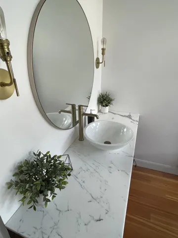 Bathroom featuring vanity and wood finished floors