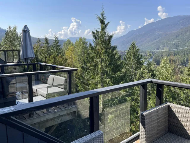 Balcony featuring a mountain view and a forest view
