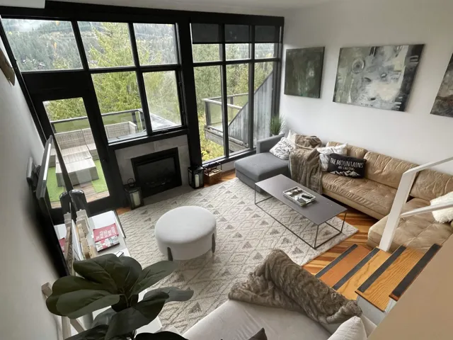 Living room with Douglas Fir flooring under the large area rug. Natural Gas fireplace is on Fortis Meter at south end of the townhomes.