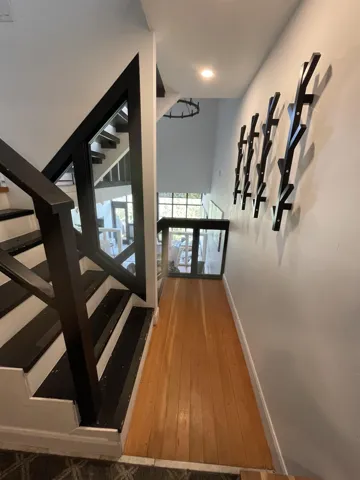 Staircase featuring baseboards and wood-type flooring