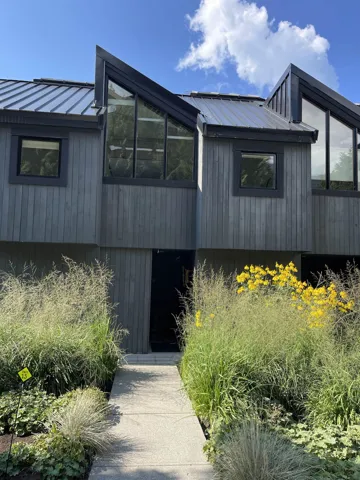 View of property exterior with a metal roof and a standing seam roof