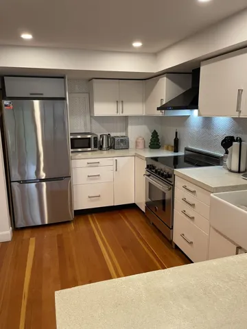 Kitchen view over the seating counter at top of stairs from Sunken Living Room & Balcony Deck.