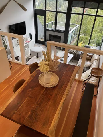 Dining area featuring a glass covered fireplace and light wood-style flooring