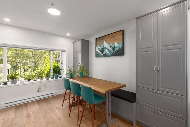 Dining room with light wood-style floors, baseboard heating, and recessed lighting