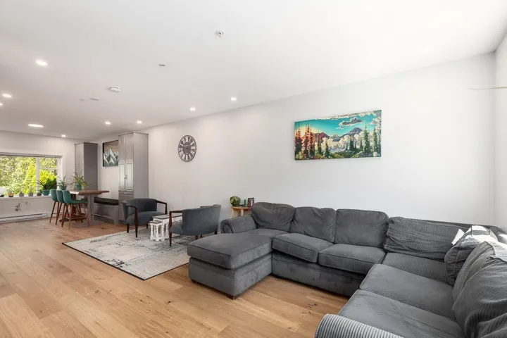 Living area featuring light wood finished floors and recessed lighting