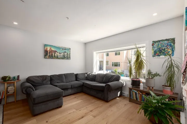 Living area featuring light wood-type flooring, recessed lighting, and baseboard heating