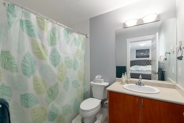 Ensuite bathroom with vanity and curtained shower