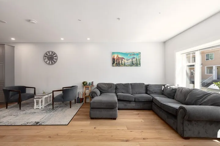 Living area featuring light wood-type flooring and recessed lighting