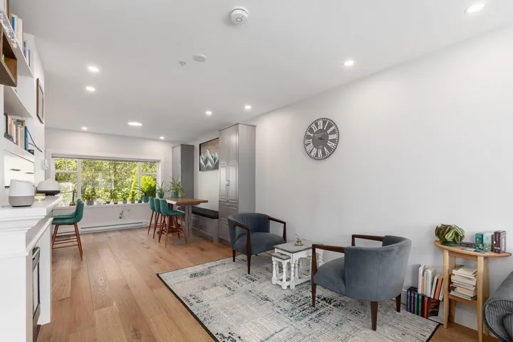 Living area featuring light wood finished floors, recessed lighting, and baseboard heating
