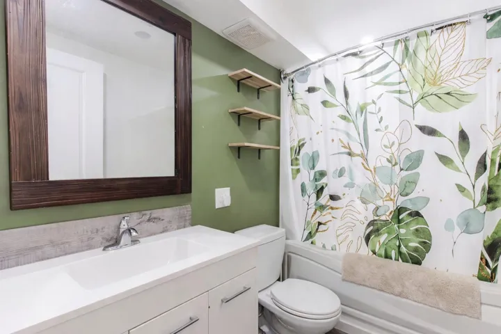 Full bath featuring vanity and shower / bathtub combination with curtain