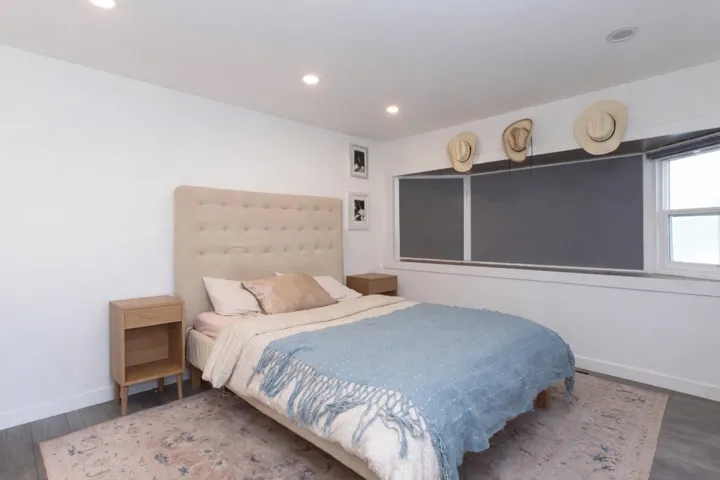 Bedroom with wood finished floors and recessed lighting