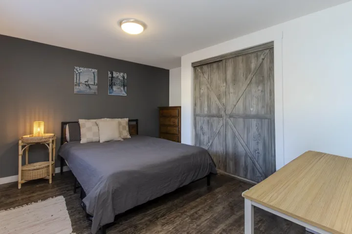 Bedroom featuring baseboards and dark wood-style floors