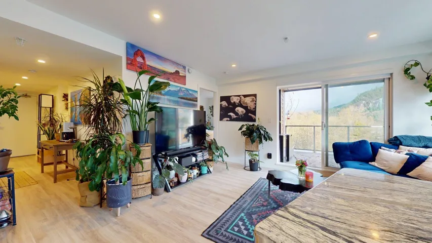 Living area featuring light wood-type flooring and recessed lighting