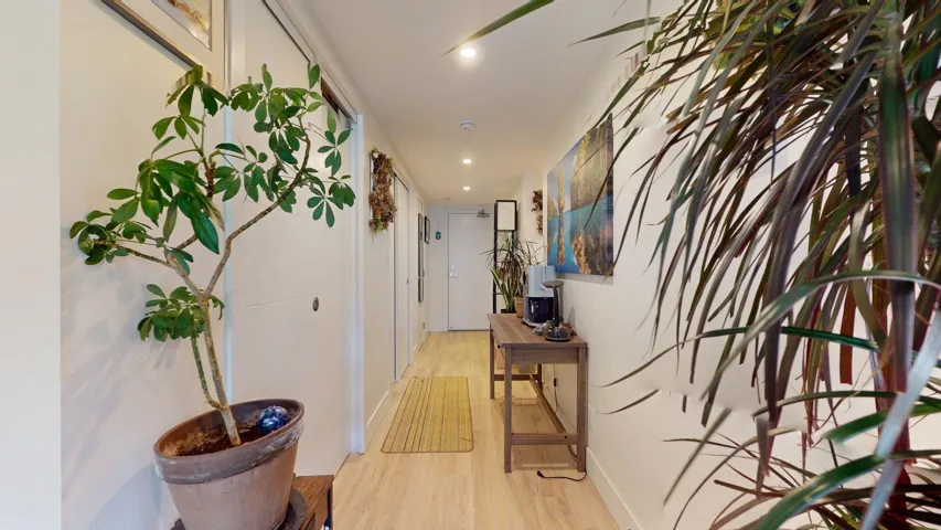 Hall featuring light wood-style flooring and recessed lighting