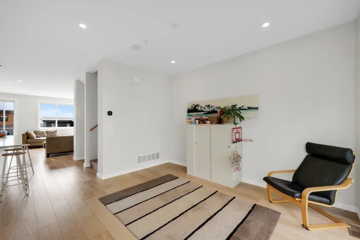 Bright open-concept interior featuring light wood-finish flooring throughout