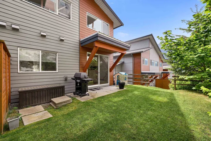 Expansive grassy yard with a concrete patio