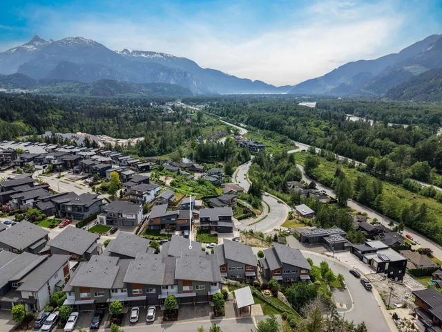 Aerial perspective showcasing a residential community nestled within a mountainous valley