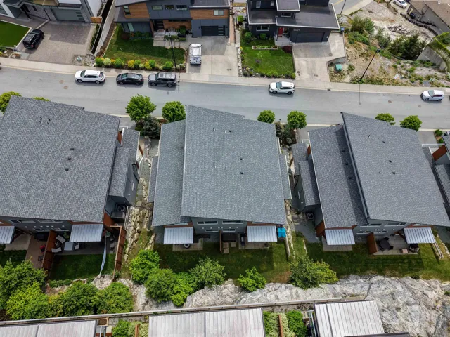 Aerial perspective showcasing residential properties with dark shingle roofs