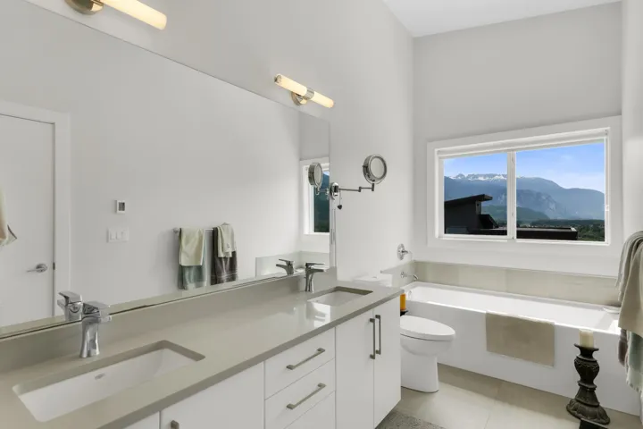Contemporary bathroom featuring a double vanity with integrated sinks and chrome fixtures
