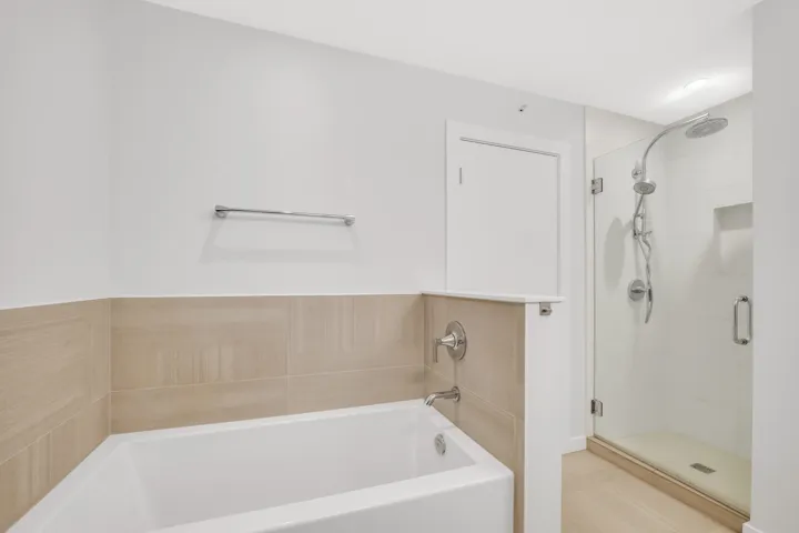 Laundry area featuring cabinet space and stacked washer and dryer