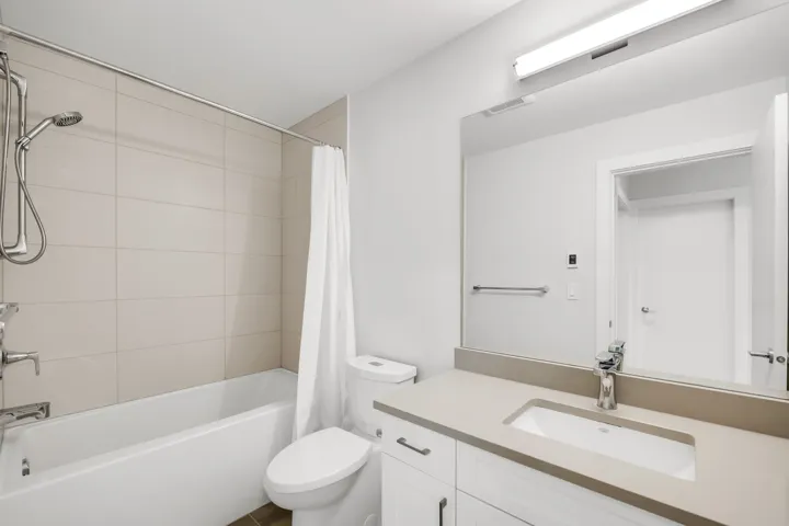 Kitchen featuring white cabinetry, stainless steel appliances, and decorative light fixtures