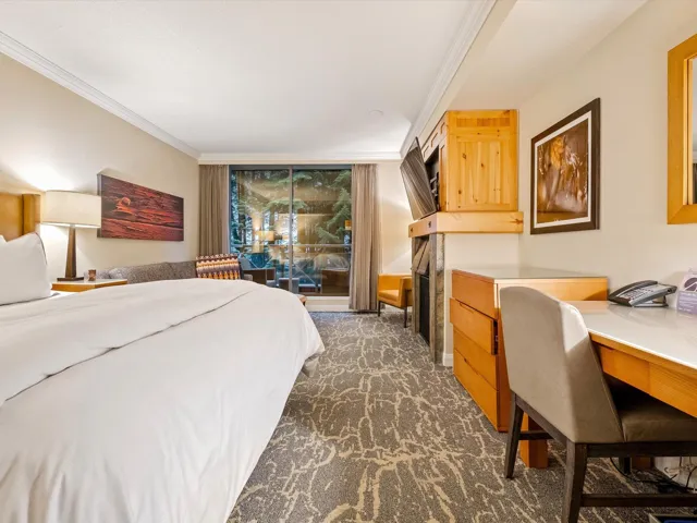 Bedroom featuring dark carpet, built in study area, and crown molding