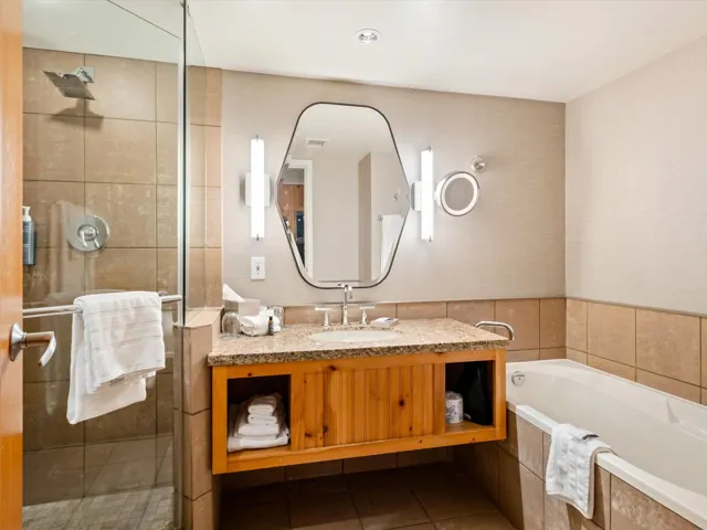 Bathroom with a stall shower, tile patterned floors, a bath, and vanity