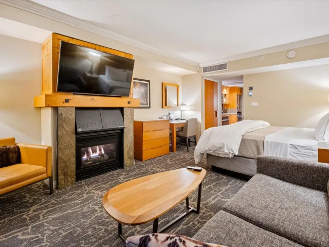 Bedroom with ornamental molding, a tiled fireplace, and visible vents