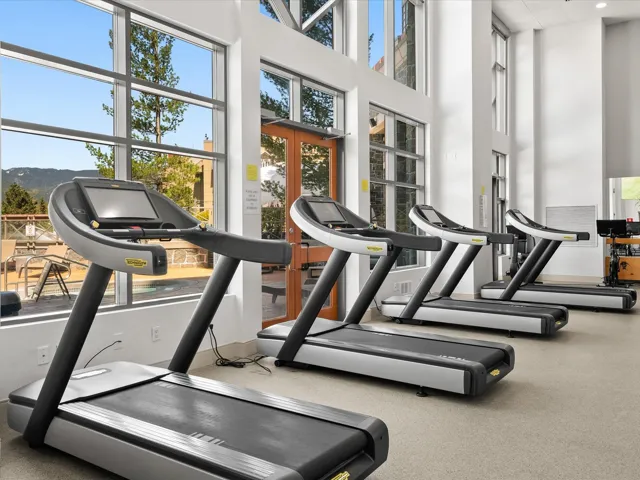 Workout area with a towering ceiling and a wealth of natural light
