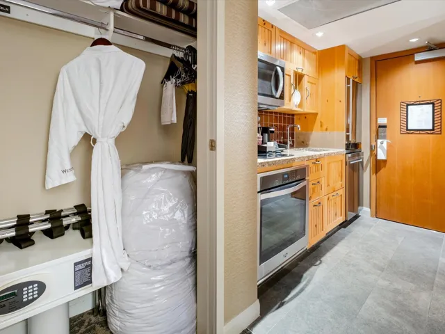 Kitchen featuring decorative backsplash, appliances with stainless steel finishes, light stone countertops, a sink, and recessed lighting