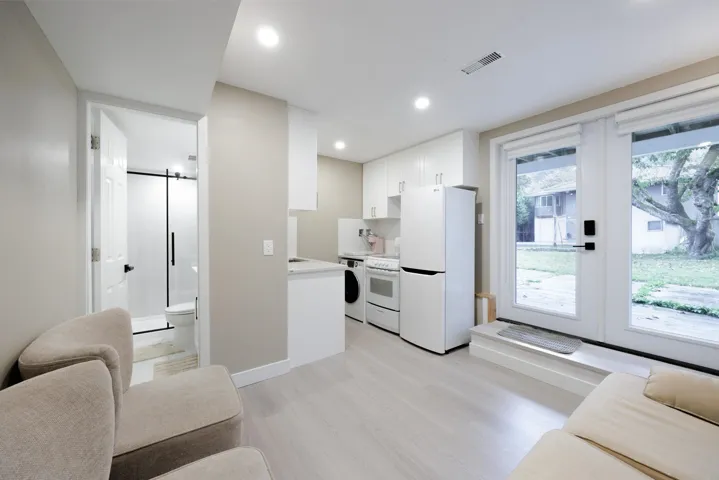 Kitchenette featuring white cabinetry, wood-finish flooring, recessed lighting, and dual glass-panel exterior doors