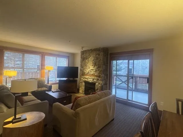 Carpeted living area featuring a fireplace