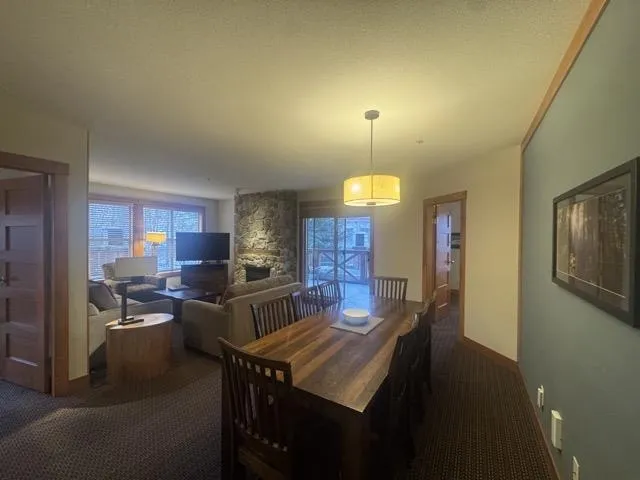 Carpeted dining space with baseboards