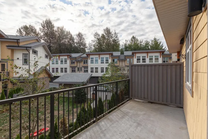 Private balcony featuring a concrete surface and black metal railings