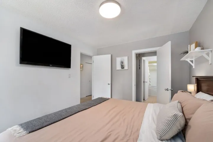 Bedroom featuring soft gray wall tones and a ceiling-mounted light fixture