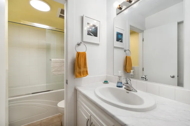 Vanity with an integrated oval sink and a stone-finish countertop