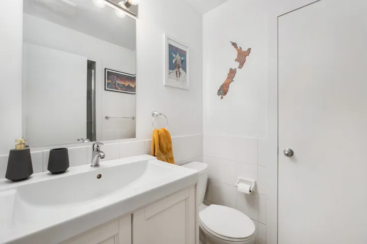 Bathroom featuring a vanity with an integrated sink, chrome faucet, and mirrored medicine cabinet