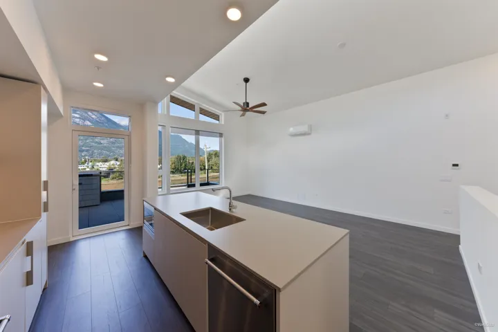 Modern kitchen island with an undermount sink and integrated stainless steel dishwasher
