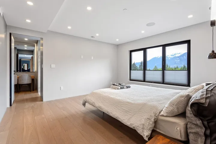 Bedroom with light wood finished floors and recessed lighting