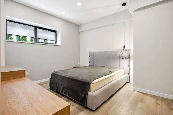 Bedroom with light wood-style flooring, recessed lighting, and baseboards
