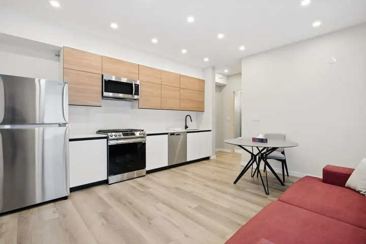 Kitchen with stainless steel appliances, light wood finished floors, recessed lighting, baseboards, and light countertops